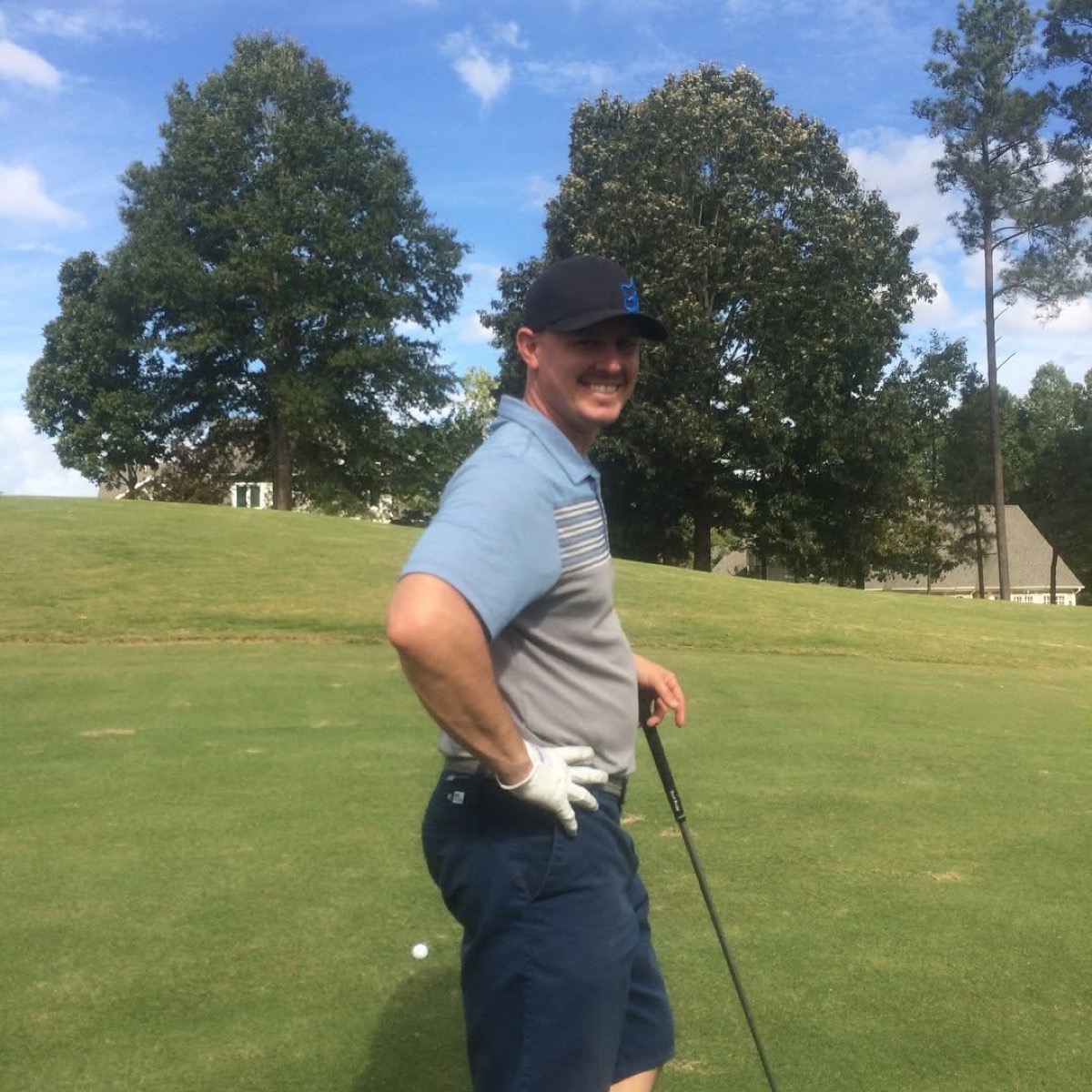 Cory Harrilchak smiling on the golf course